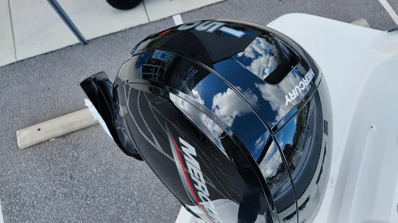 Slide: The Image of 2025 Bayliner VR6 with Mercury outboard motor reflecting sky and clouds. - 11