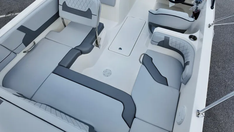 Slide: The Image of 2025 Bayliner VR6 boat interior with gray seating and modern design. - 12