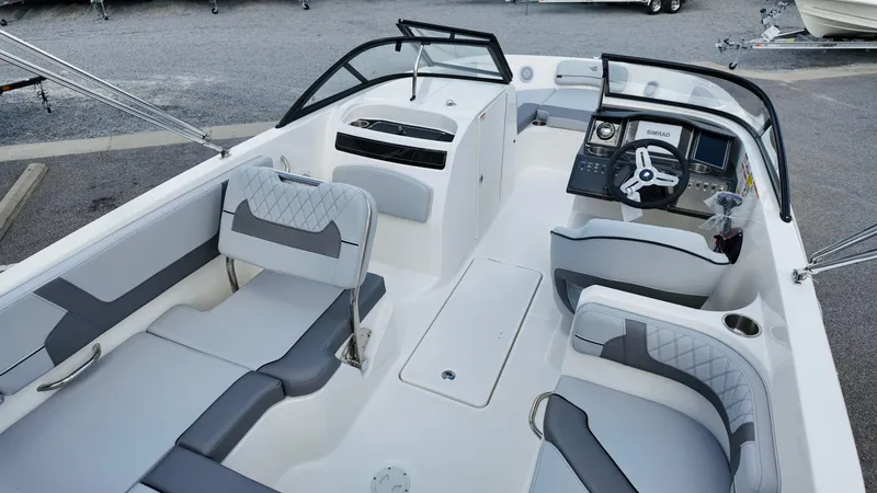 Slide: The Image of 2025 Bayliner VR6 boat interior with modern seating and steering console. - 13