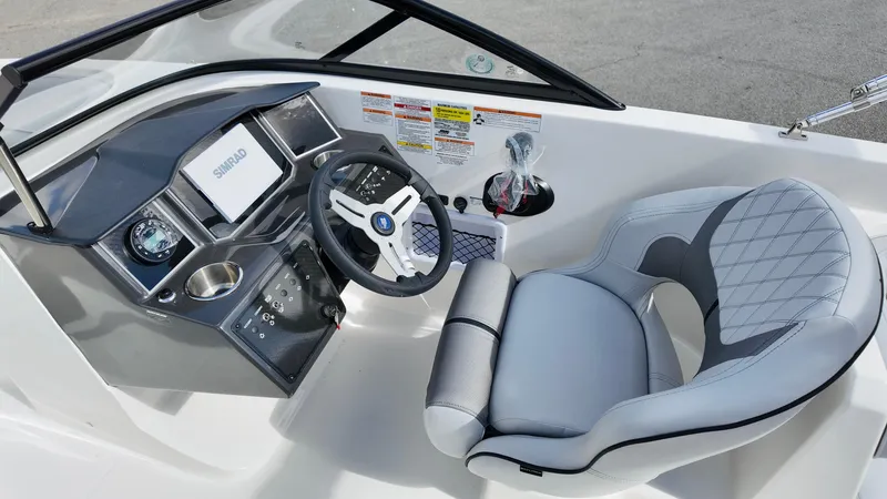 Slide: The Image of 2025 Bayliner VR6 boat cockpit with modern steering and comfortable seating. - 18