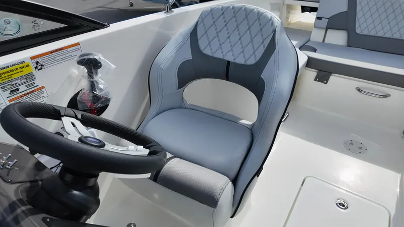 Slide: The Image of 2025 Bayliner VR6 boat interior with modern steering wheel and comfortable seating. - 20