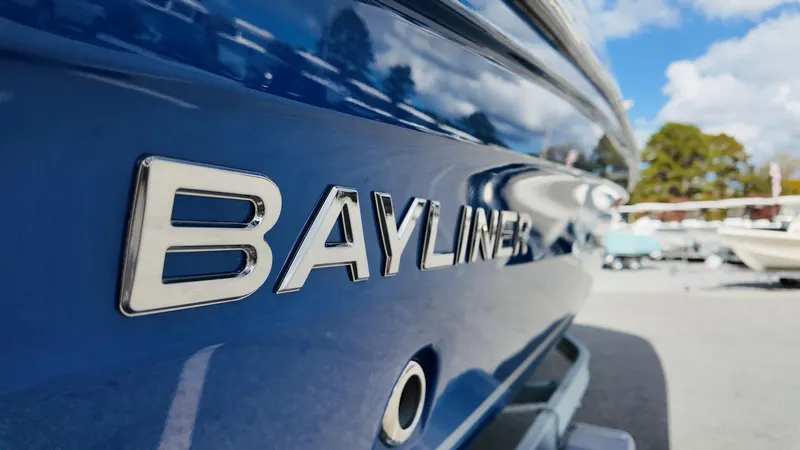 Slide: The Image of Close-up of a 2025 Bayliner VR6 boat with blue exterior and logo. - 5