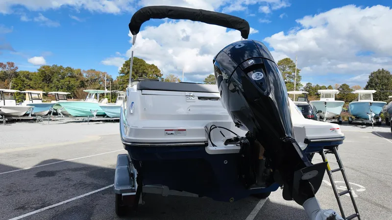 Slide: The Image of 2025 Bayliner VR6 boat with outboard motor in a marina setting. - 6