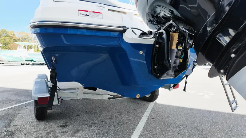 Slide: The Image of 2025 Bayliner VR6 boat on trailer, rear view, blue hull, outboard motor. - 7