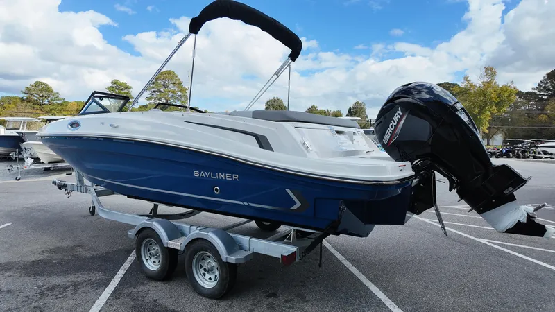 Slide: The Image of 2025 Bayliner VR6 boat on trailer, featuring sleek design and powerful Mercury outboard motor. - 8