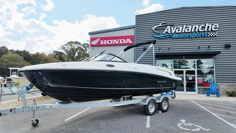 The Image of 2025 Bayliner VR6 boat on trailer at Avalanche Motorsports dealership. - 1