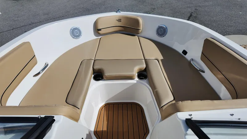 Slide: The Image of 2025 Bayliner VR6 boat interior with tan seating and wood accents. - 11