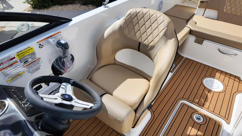 Slide: The Image of 2025 Bayliner VR6 boat interior with tan leather seating and wood-style flooring. - 16