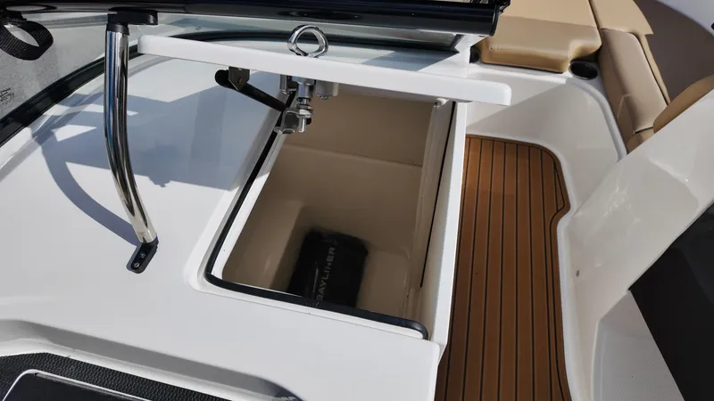 Slide: The Image of 2025 Bayliner VR6 boat interior with open storage compartment and teak flooring. - 17