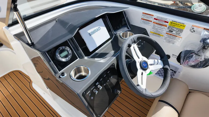 Slide: The Image of 2025 Bayliner VR6 boat dashboard with steering wheel, digital display, and control panel. - 19