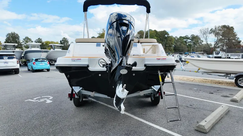Slide: The Image of 2025 Bayliner VR6 boat on trailer, rear view with outboard motor and ladder. - 5