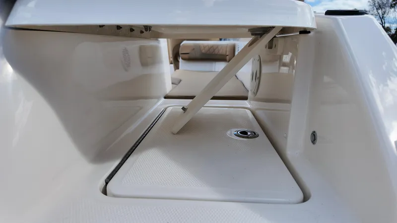 Slide: The Image of 2025 Bayliner VR6 boat storage compartment with open hatch, showcasing interior design. - 7