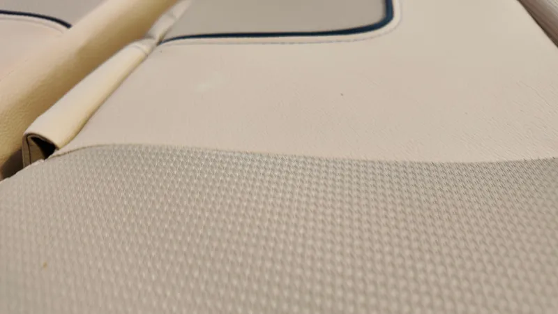 Slide: The Image of 2025 Bayliner VR6 boat interior upholstery, featuring beige textured seating. - 8