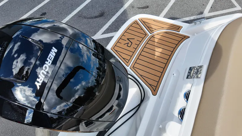 Slide: The Image of 2025 Bayliner VR6 boat with Mercury engine, featuring sleek design and wooden deck accents. - 9