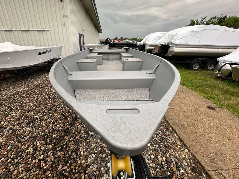 Slide: The Image of 2025 Alumacraft V14 boat displayed outdoors, surrounded by other covered boats. - 3