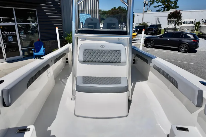 Slide: The Image of 2025 Defiance 240 Catalina boat interior with cushioned seating and modern design. - 12