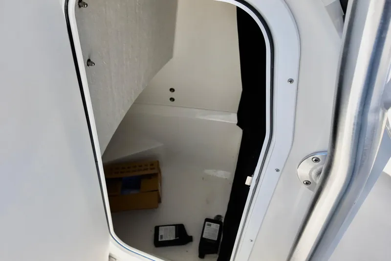 Slide: The Image of Interior view of 2025 Defiance 240 Catalina boat cabin with storage items. - 3