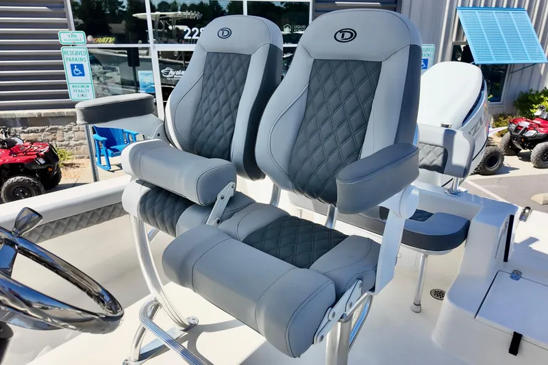 Slide: The Image of Luxury seating on 2025 Defiance 240 Catalina boat, featuring quilted gray upholstery. - 10