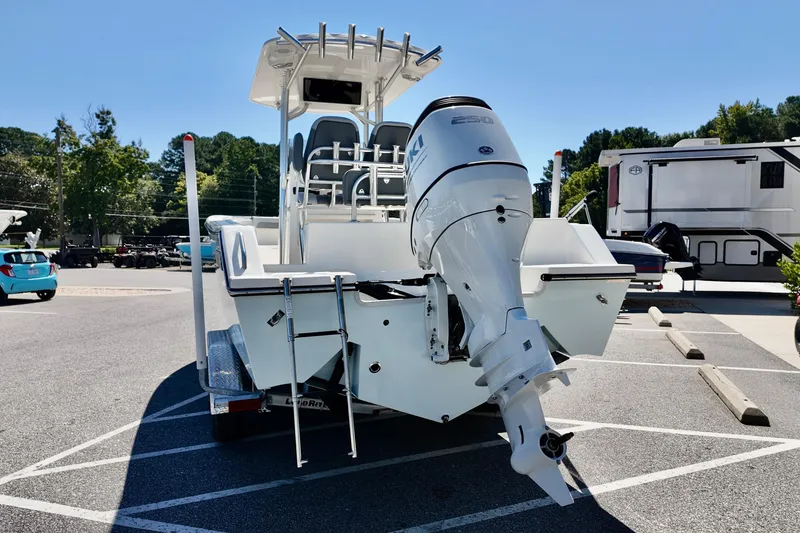 Slide: The Image of 2025 Defiance 240 Catalina boat with powerful outboard motor in a parking lot. - 15