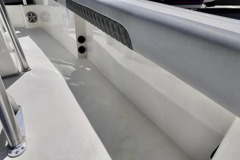 Slide: The Image of Interior view of 2025 Defiance 240 Catalina boat, featuring sleek white surfaces and stainless steel details. - 6