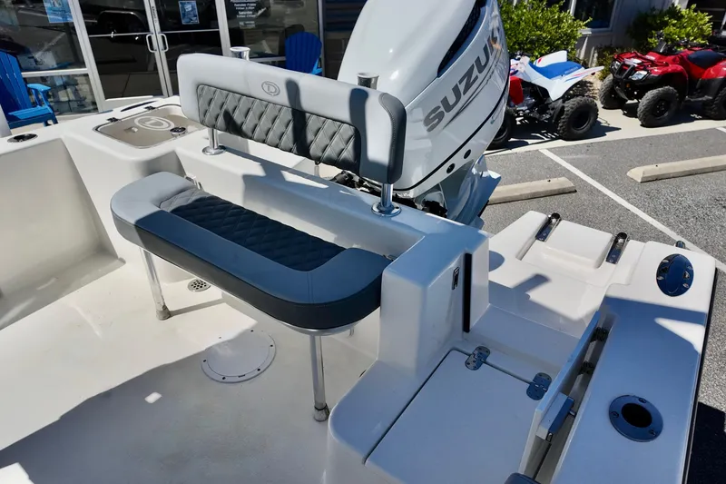 Slide: The Image of 2025 Defiance 240 Catalina boat interior with Suzuki engine, featuring seating and storage. - 8