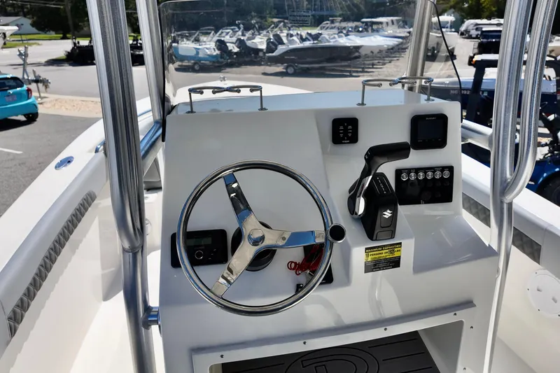 Slide: The Image of 2025 Defiance 240 Catalina boat helm with steering wheel and control panel. - 9