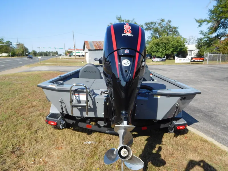 Slide: The Image of 2025 Vexus AVX 1980 boat with powerful outboard motor, parked on grass. - 12