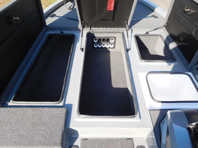 Slide: The Image of 2025 Vexus AVX 1980 boat interior with storage compartments and rod holders. - 6