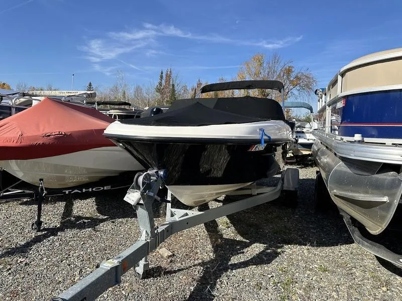 Slide: The Image of 2018 Bayliner VR4 boat on trailer, parked outdoors among other boats. - 1