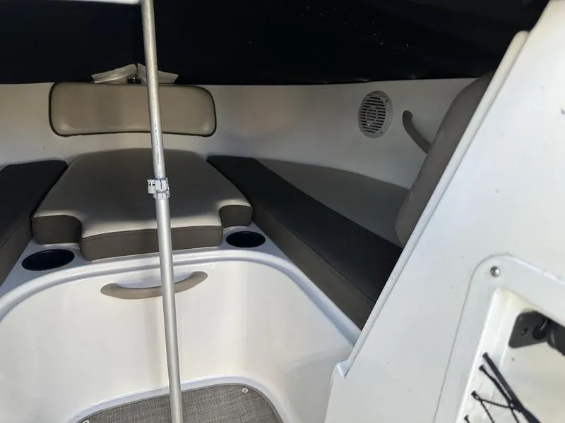 Slide: The Image of 2018 Bayliner VR4 boat interior with cushioned seating and storage compartments. - 10