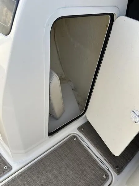 Slide: The Image of 2018 Bayliner VR4 boat storage compartment with open door. - 11