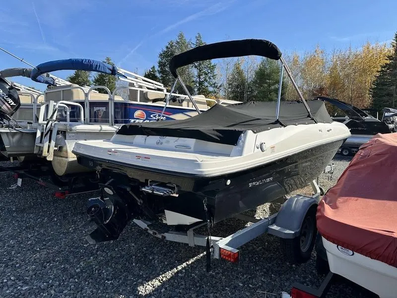 Slide: The Image of 2018 Bayliner VR4 boat with cover on trailer, parked outdoors. - 2