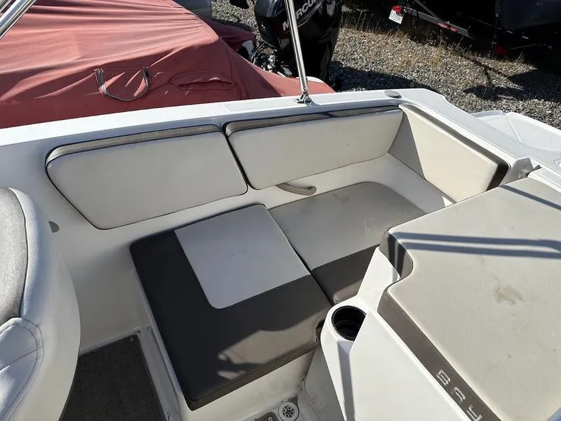 Slide: The Image of 2018 Bayliner VR4 boat interior with cushioned seating and cup holder. - 5