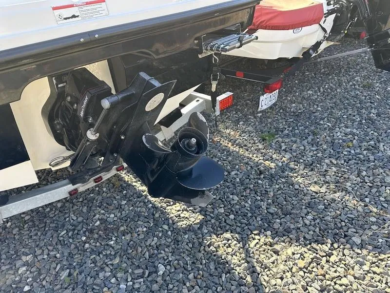 Slide: The Image of 2018 Bayliner VR4 boat propeller and stern on gravel surface. - 6