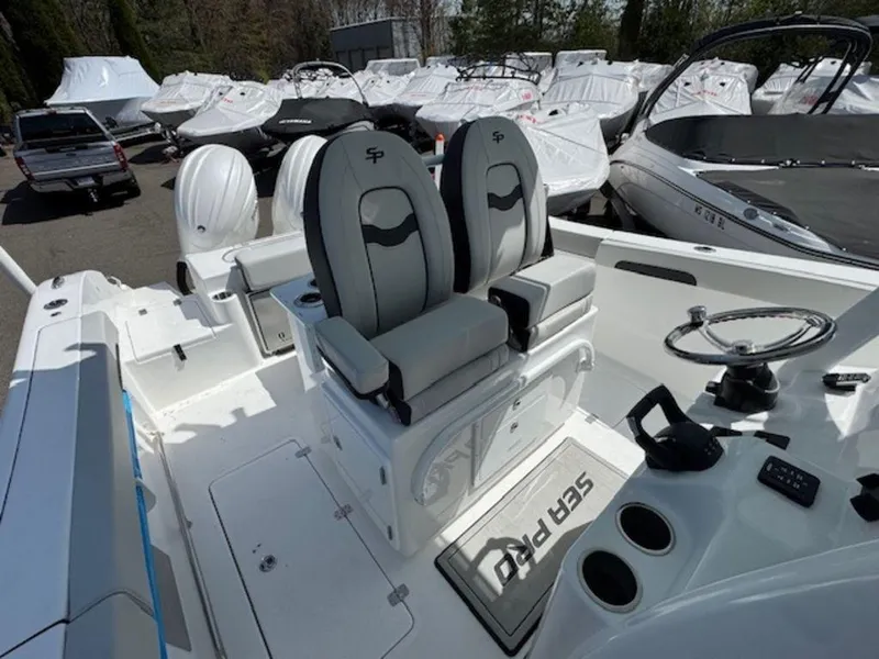 Slide: The Image of 2025 Sea Pro 262 DLX boat interior with dual seats and steering wheel. - 11