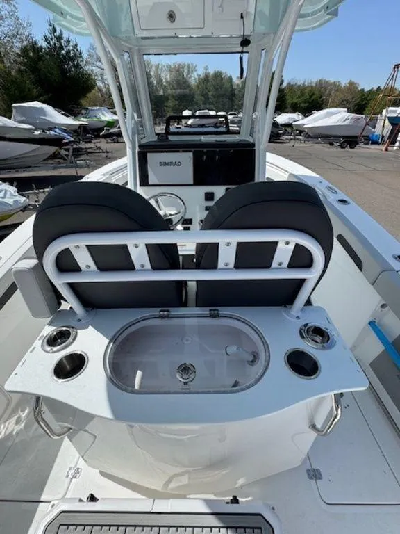 Slide: The Image of 2025 Sea Pro 262 DLX boat interior with seating and control panel. - 13