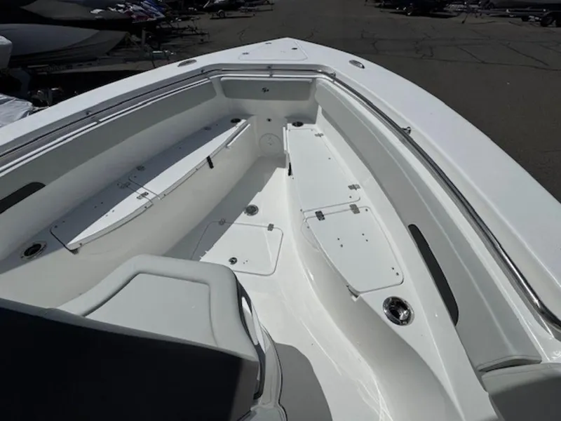 Slide: The Image of 2025 Sea Pro 262 DLX boat interior, featuring spacious seating and storage compartments. - 17