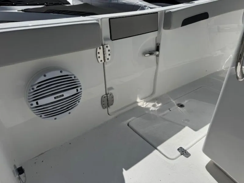 Slide: The Image of 2025 Sea Pro 262 DLX boat interior with speaker and storage compartment. - 18