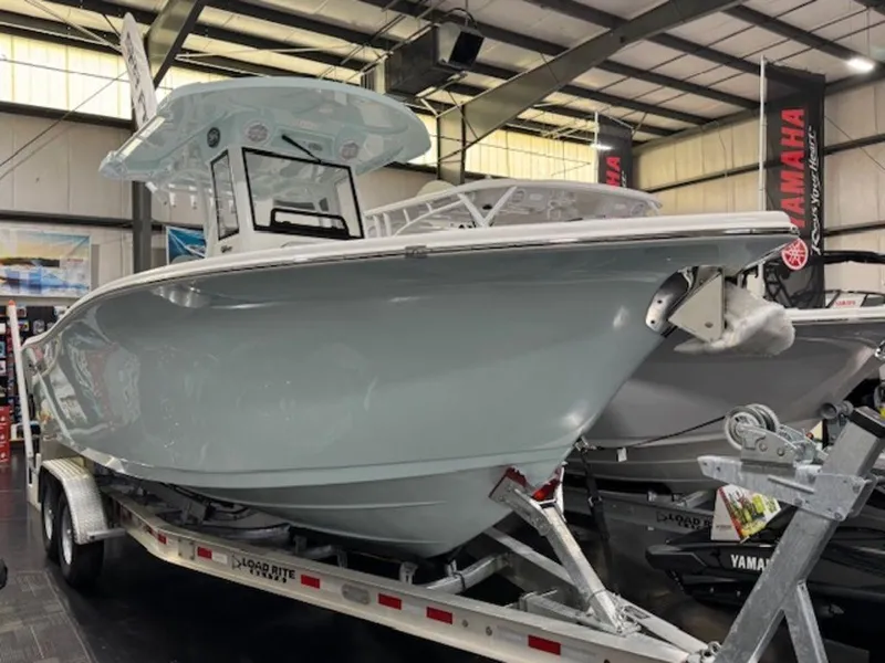 Slide: The Image of 2025 Sea Pro 262 DLX boat on trailer in indoor showroom. - 5