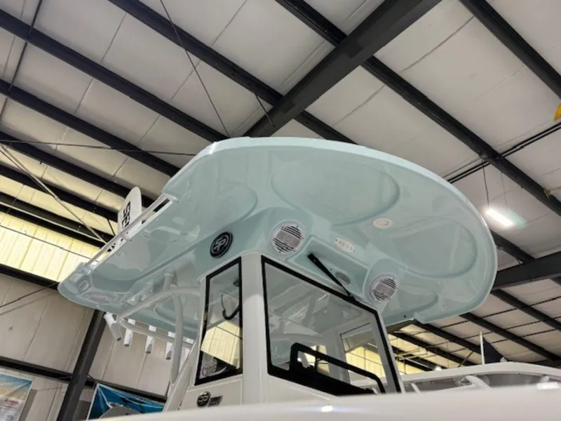 Slide: The Image of 2025 Sea Pro 262 DLX boat with sleek design in a showroom. - 6