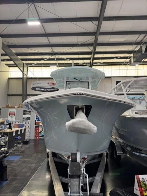 Slide: The Image of 2025 Sea Pro 262 DLX boat displayed indoors on a trailer. - 7