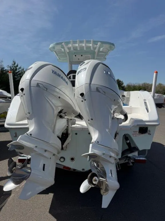 Slide: The Image of 2025 Sea Pro 262 DLX boat with dual Yamaha outboard engines, rear view. - 8