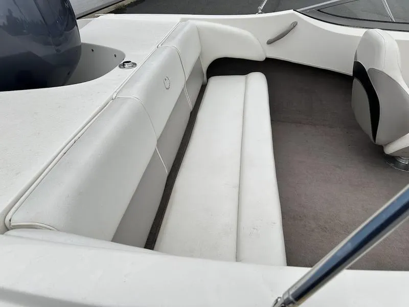 Slide: The Image of 2015 Stingray 191RX boat interior with white seating and gray carpet. - 11