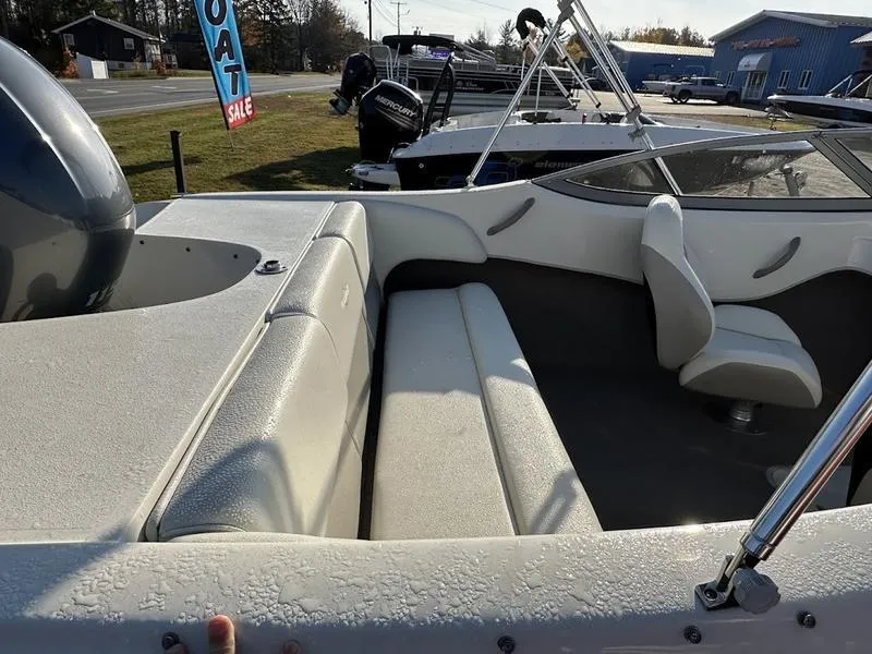 Slide: The Image of 2015 Stingray 191RX boat interior with seating and steering wheel, displayed outdoors. - 4