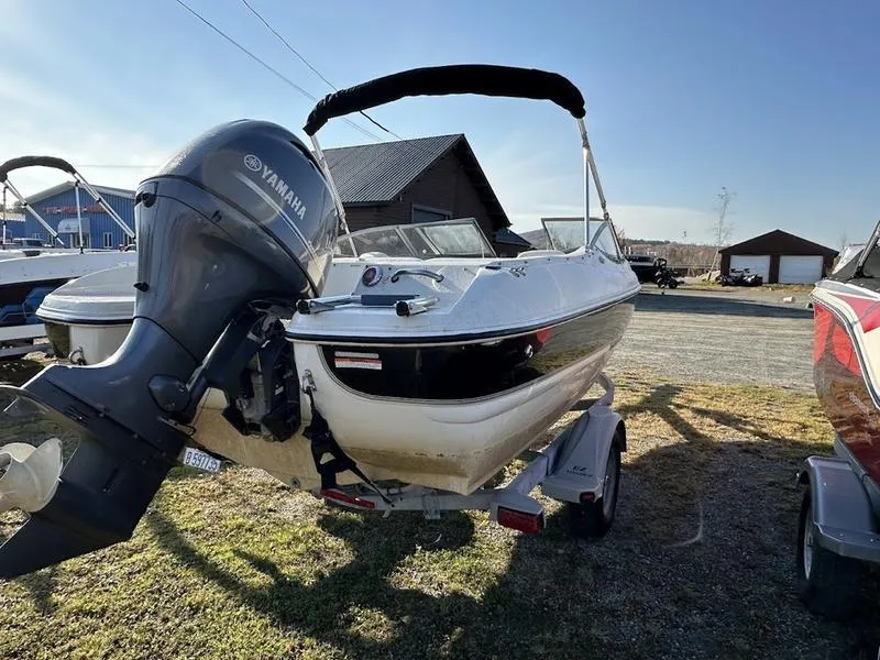 Slide: The Image of 2015 Stingray 191RX boat with Yamaha outboard motor on trailer, parked outdoors. - 9