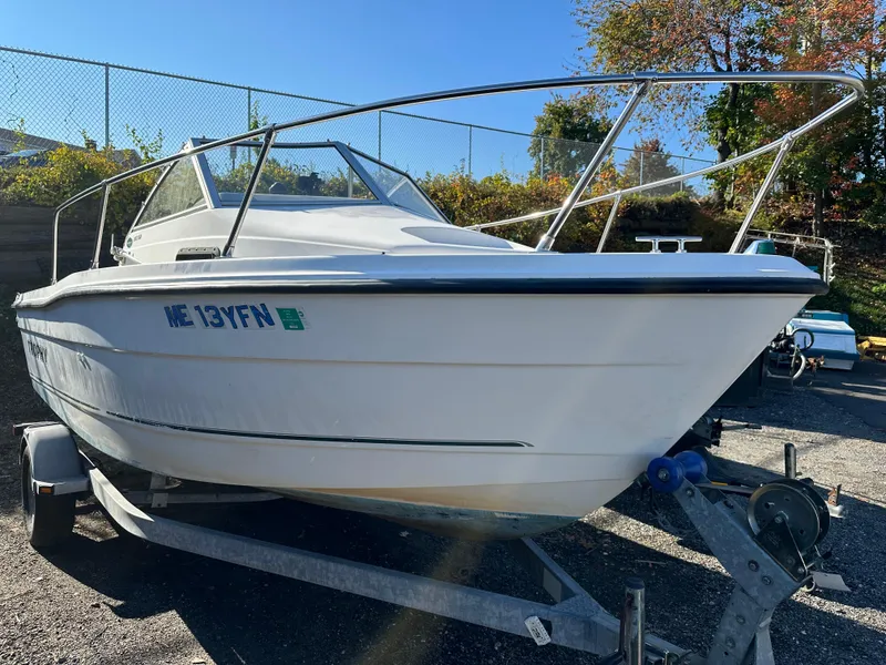 Slide: The Image of 2006 Trophy 1802 WA boat on trailer, parked outdoors. - 12