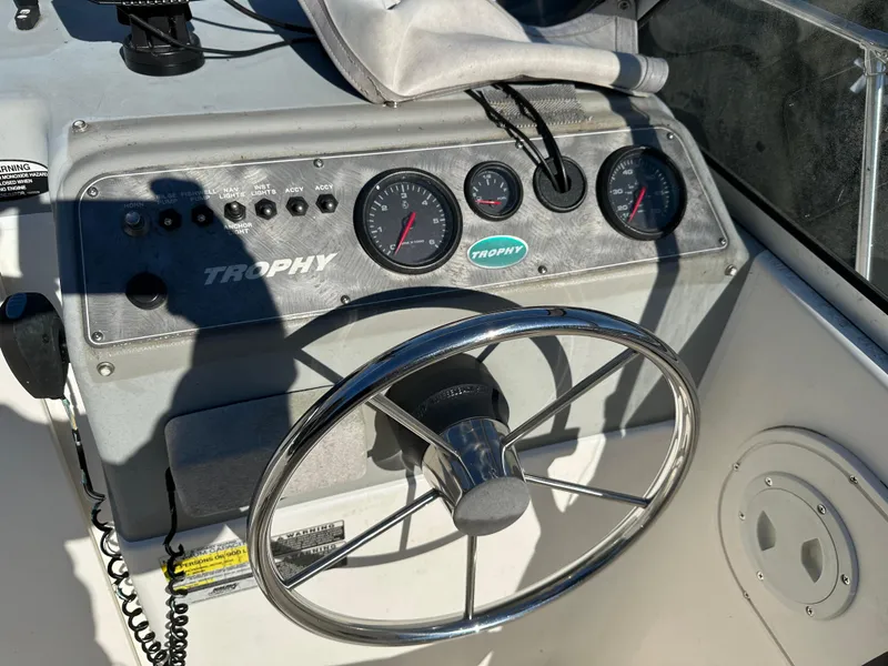 Slide: The Image of 2006 Trophy 1802 WA boat dashboard with steering wheel and gauges. - 7
