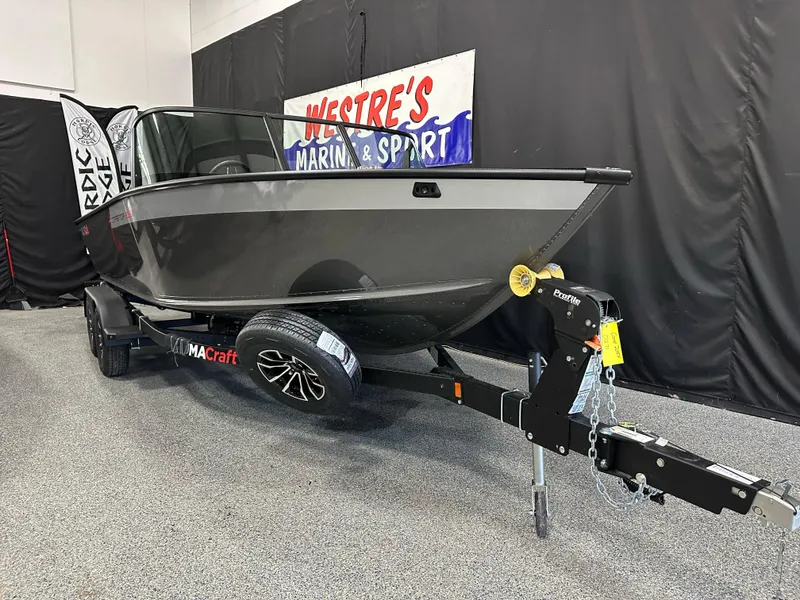 Slide: The Image of 2025 Alumacraft Competitor 205X Sport boat on display at Westre's Marine & Sport showroom. - 1