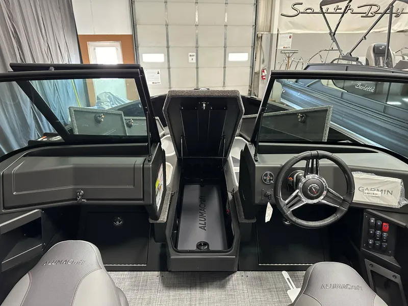 Slide: The Image of Interior view of 2025 Alumacraft Competitor 205X Sport boat, featuring steering wheel and dashboard. - 11