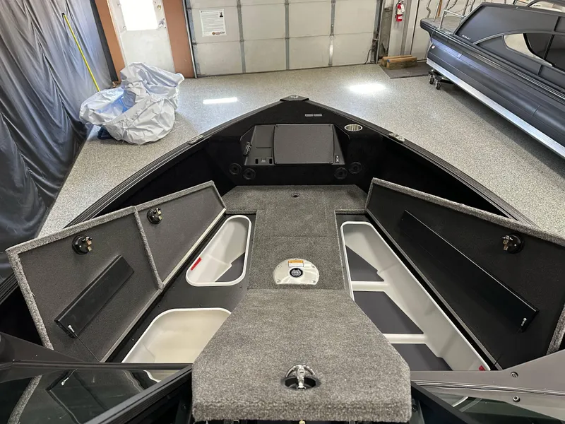 Slide: The Image of 2025 Alumacraft Competitor 205X Sport boat interior with open storage compartments. - 12